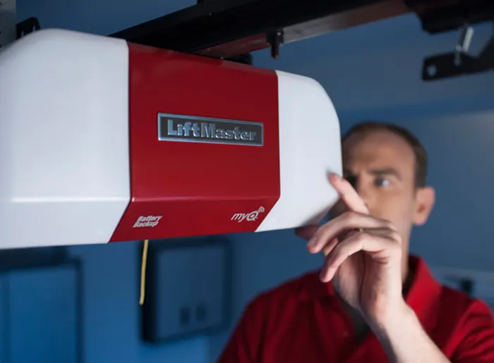 Technician working on a garage door opener